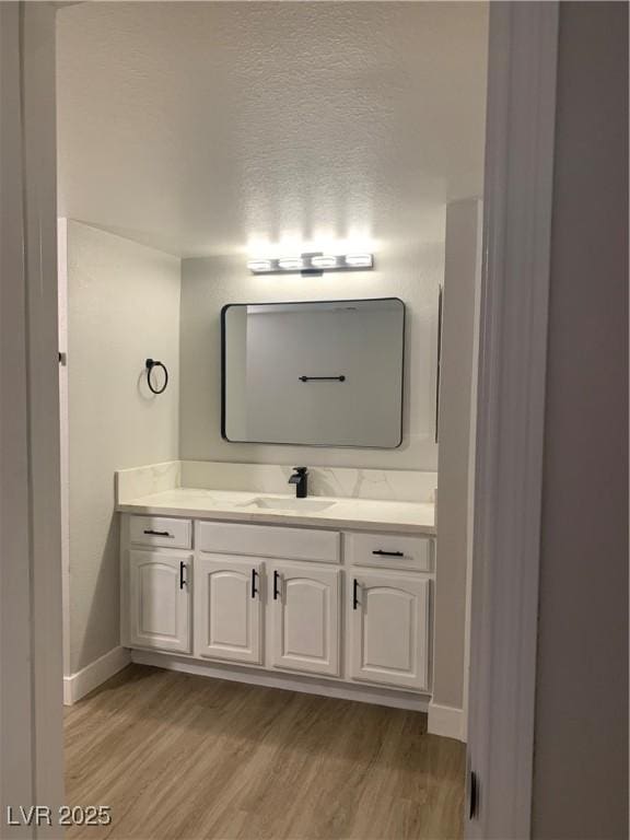8101 W Flamingo Rd Unit 1102, Las Vegas, NV 89147 - bathroom with wood finished floors and vanity