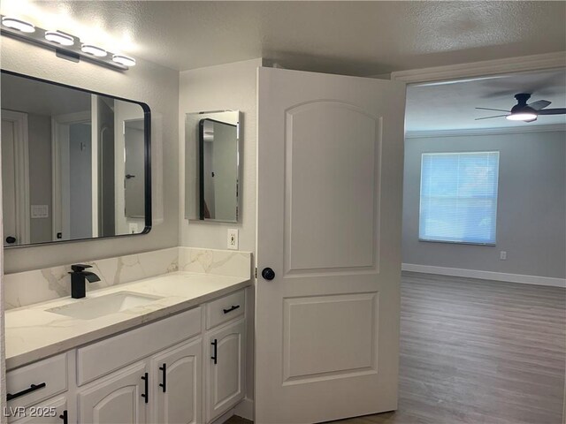 8101 W Flamingo Rd Unit 1102, Las Vegas, NV 89147 - bathroom featuring vanity, wood finished floors, and ceiling fan