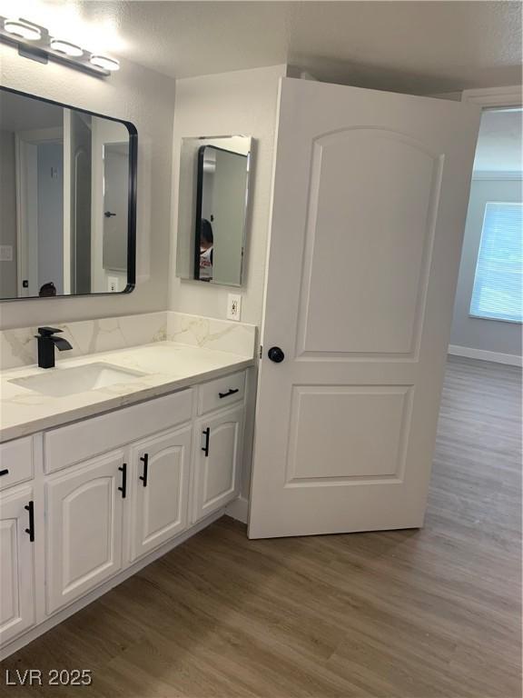 8101 W Flamingo Rd Unit 1102, Las Vegas, NV 89147 - bathroom with vanity and wood finished floors