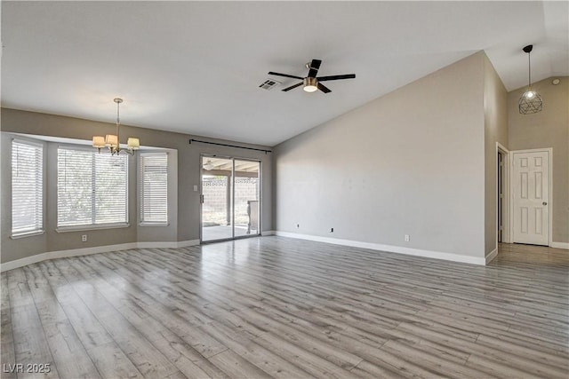 8517 Soneto Ln, Las Vegas, NV 89117 - unfurnished living room featuring lofted ceiling, a chandelier, wood finished floors, and ceiling fan