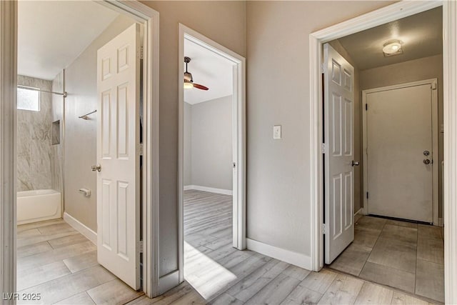 8517 Soneto Ln, Las Vegas, NV 89117 - hallway featuring light wood-type flooring and baseboards