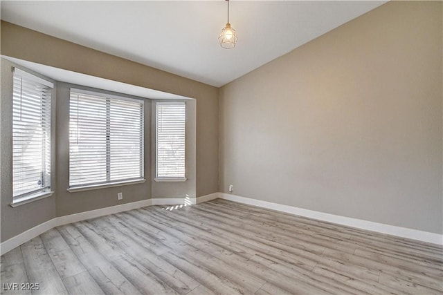8517 Soneto Ln, Las Vegas, NV 89117 - unfurnished room with light wood-style flooring and vaulted ceiling