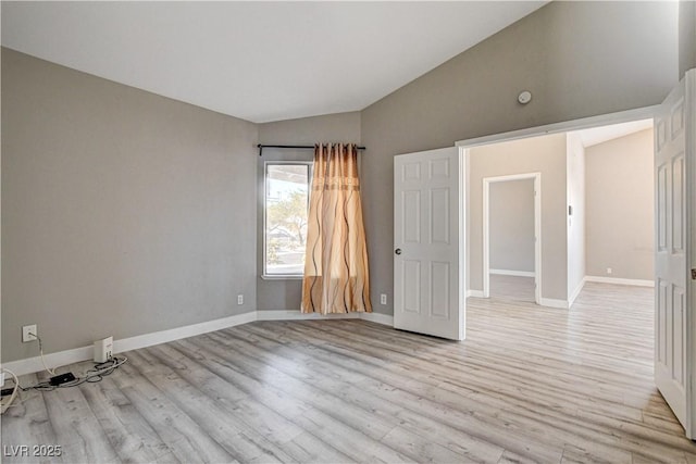 8517 Soneto Ln, Las Vegas, NV 89117 - empty room featuring lofted ceiling and light wood finished floors
