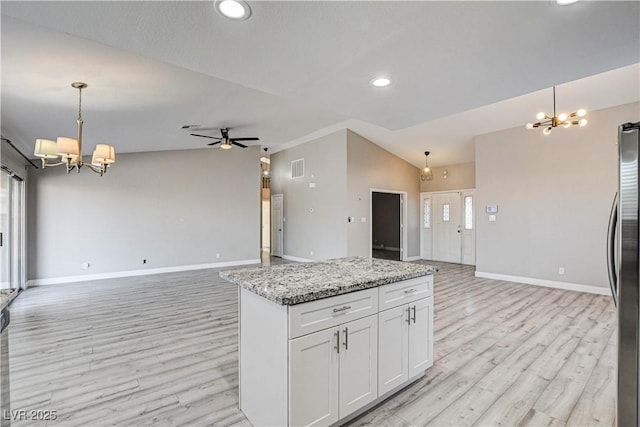 8517 Soneto Ln, Las Vegas, NV 89117 - kitchen featuring a chandelier, freestanding refrigerator, open floor plan, light wood-style flooring, and recessed lighting