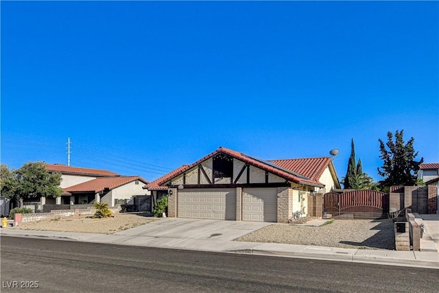 8517 Soneto Ln, Las Vegas, NV 89117 - view of front of home featuring an attached garage, a gate, a tile roof, driveway, and stucco siding
