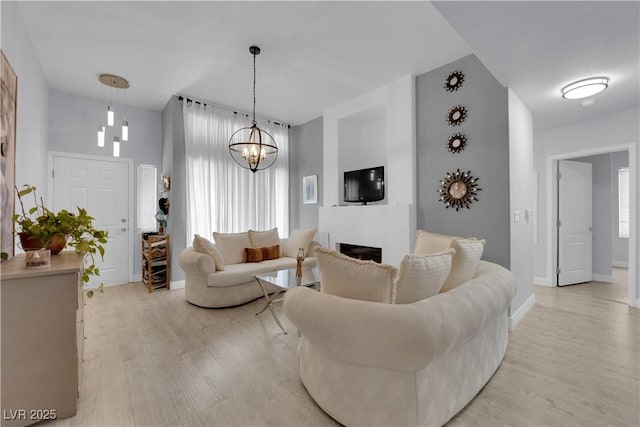 2305 W Horizon Ridge Parkway Unit 611, Henderson, NV 89052 - living room with light wood-style floors, a fireplace, and a chandelier