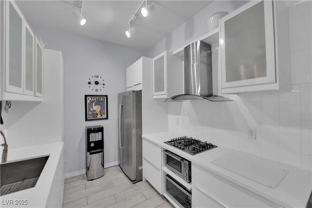 2305 W Horizon Ridge Parkway Unit 611, Henderson, NV 89052 - kitchen featuring appliances with stainless steel finishes, wall chimney range hood, white cabinets, light countertops, and glass insert cabinets