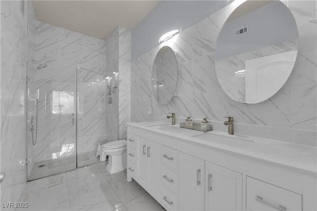 2305 W Horizon Ridge Parkway Unit 611, Henderson, NV 89052 - bathroom featuring marble look tile flooring, double vanity, a marble finish shower, and tile walls