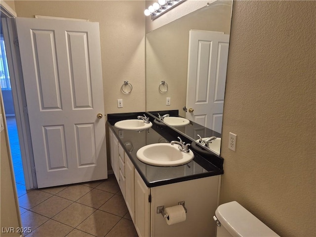 2900 Sunridge Heights Pkwy Unit 418, Henderson, NV 89052 - bathroom with tile patterned floors, a textured wall, and double vanity