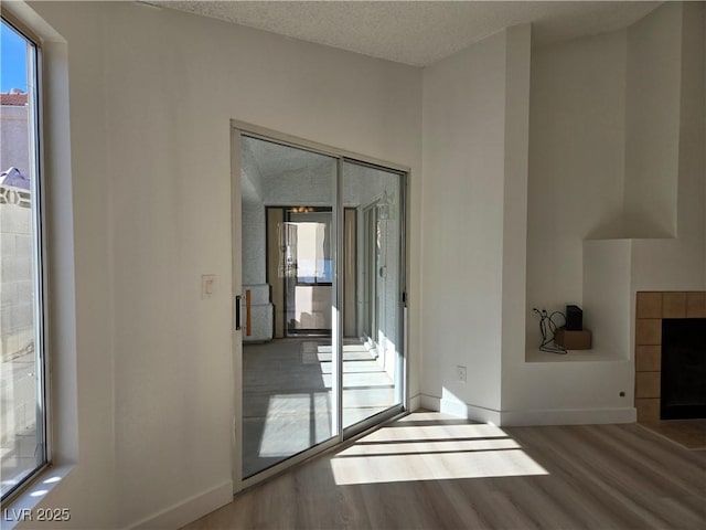6636 Old Oxford Ave, Las Vegas, NV 89108 - unfurnished living room with wood finished floors and a textured ceiling