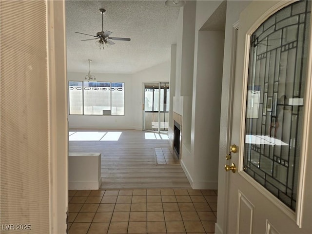 6636 Old Oxford Ave, Las Vegas, NV 89108 - hallway featuring a textured ceiling, tile patterned flooring, and a chandelier