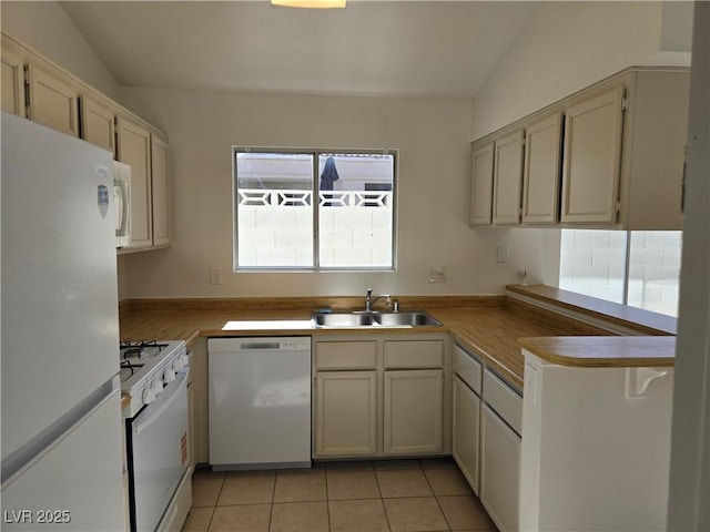 6636 Old Oxford Ave, Las Vegas, NV 89108 - kitchen with white appliances, light tile patterned flooring, and a peninsula