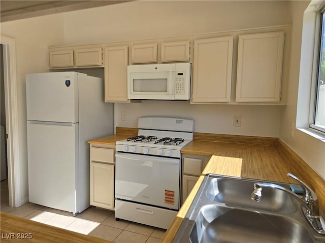 6636 Old Oxford Ave, Las Vegas, NV 89108 - kitchen featuring white appliances and light tile patterned floors