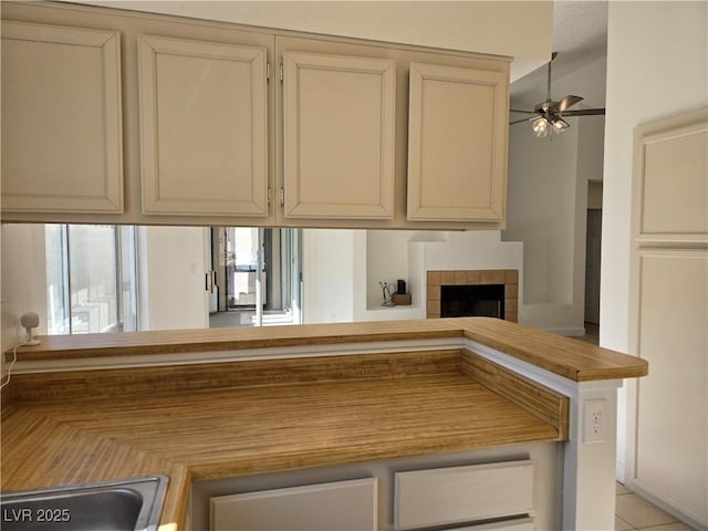 6636 Old Oxford Ave, Las Vegas, NV 89108 - kitchen with ceiling fan, a fireplace, and light countertops