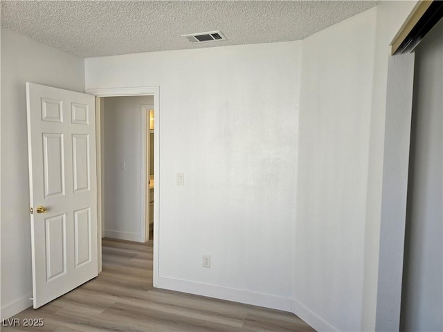 6636 Old Oxford Ave, Las Vegas, NV 89108 - unfurnished room with wood finished floors and a textured ceiling