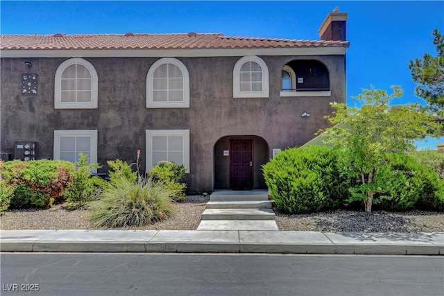 7950 W Flamingo Rd Unit 1042, Las Vegas, NV 89147 - view of front of house with a chimney and stucco siding
