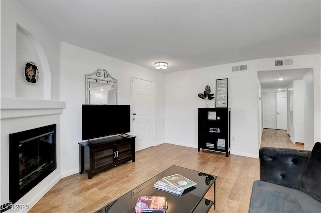 7950 W Flamingo Rd Unit 1042, Las Vegas, NV 89147 - living area featuring light wood-style floors and a large fireplace