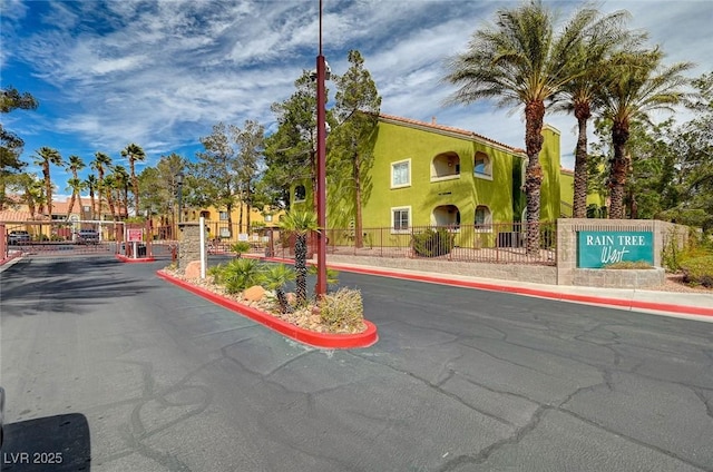 7950 W Flamingo Rd Unit 1042, Las Vegas, NV 89147 - view of asphalt road with curbs, a gated entry, and a gate