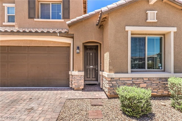 10961 Winter Rise St, Las Vegas, NV 89141 - doorway to property with stone siding, stucco siding, and decorative driveway