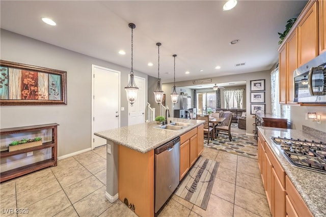 10961 Winter Rise St, Las Vegas, NV 89141 - kitchen with stainless steel appliances, recessed lighting, open floor plan, light tile patterned floors, and a kitchen island with sink
