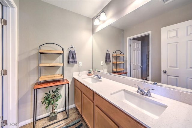 10961 Winter Rise St, Las Vegas, NV 89141 - bathroom featuring double vanity and baseboards