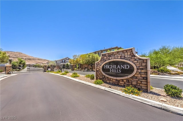 10961 Winter Rise St, Las Vegas, NV 89141 - view of asphalt road with a gated entry, a gate, and curbs