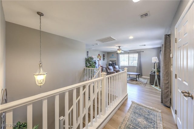 10961 Winter Rise St, Las Vegas, NV 89141 - corridor featuring light wood-style flooring and an upstairs landing