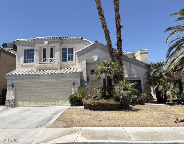 3679 Funston Way, Las Vegas, NV 89129 - mediterranean / spanish home with a tiled roof, concrete driveway, a balcony, and an attached garage