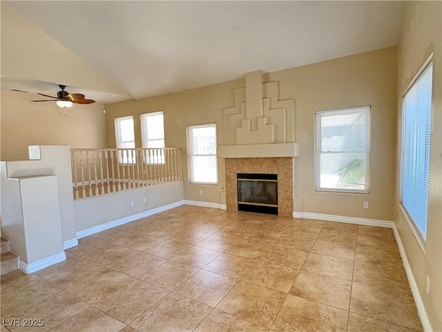3679 Funston Way, Las Vegas, NV 89129 - unfurnished living room featuring vaulted ceiling, ceiling fan, a tiled fireplace, and light tile patterned floors