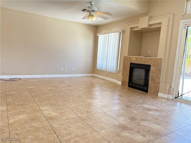 3679 Funston Way, Las Vegas, NV 89129 - unfurnished living room with healthy amount of natural light, a ceiling fan, a tiled fireplace, and light tile patterned flooring