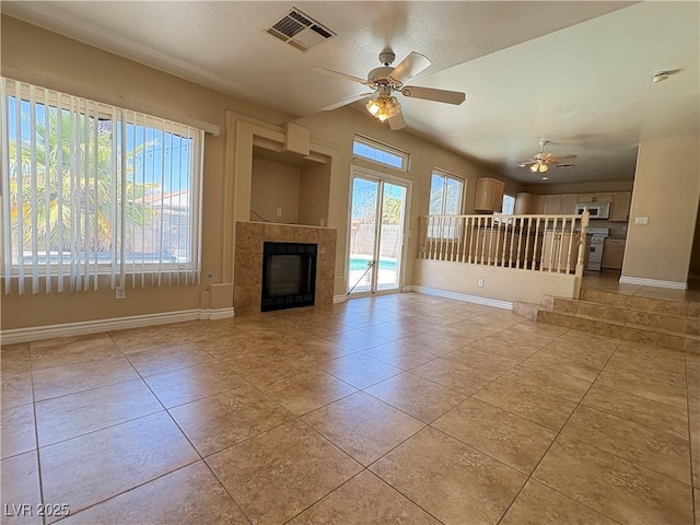 3679 Funston Way, Las Vegas, NV 89129 - unfurnished living room featuring a ceiling fan, light tile patterned floors, and a tile fireplace