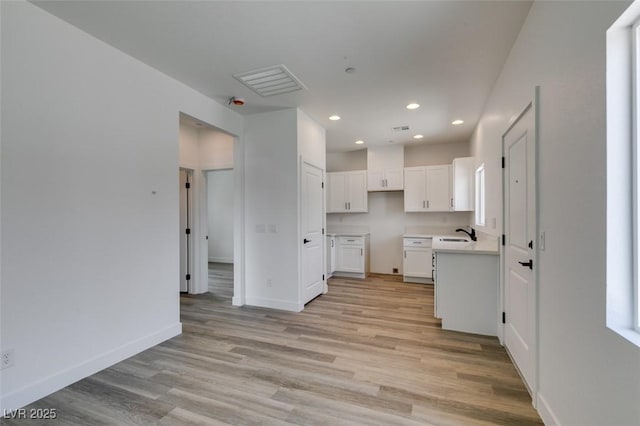 383 N 16th St, Las Vegas, NV 89101 - kitchen with light wood finished floors, white cabinets, recessed lighting, and light countertops