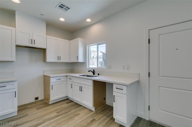 383 N 16th St, Las Vegas, NV 89101 - kitchen with white cabinetry, light wood finished floors, light countertops, and recessed lighting