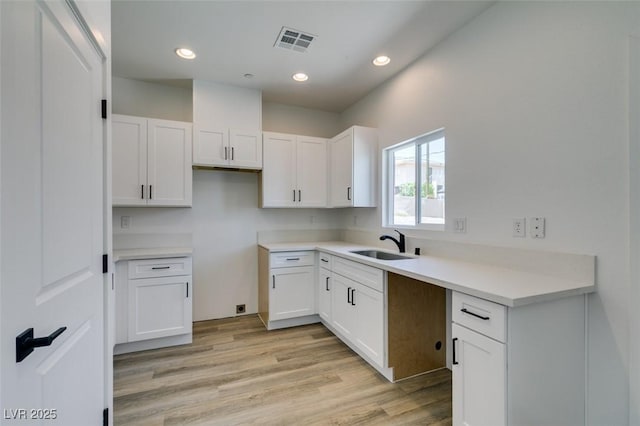 383 N 16th St, Las Vegas, NV 89101 - kitchen with white cabinetry, light wood finished floors, recessed lighting, and light countertops