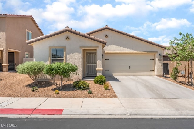 518 Descubir Ave, North Las Vegas, NV 89081 - mediterranean / spanish-style house featuring an attached garage, stucco siding, driveway, and a tile roof