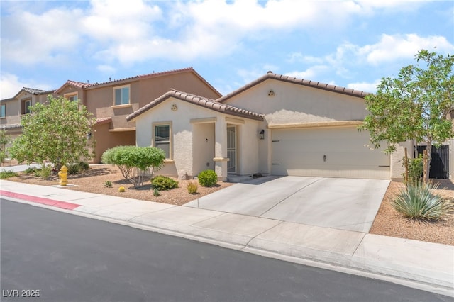 518 Descubir Ave, North Las Vegas, NV 89081 - mediterranean / spanish home with stucco siding, an attached garage, driveway, and a tiled roof