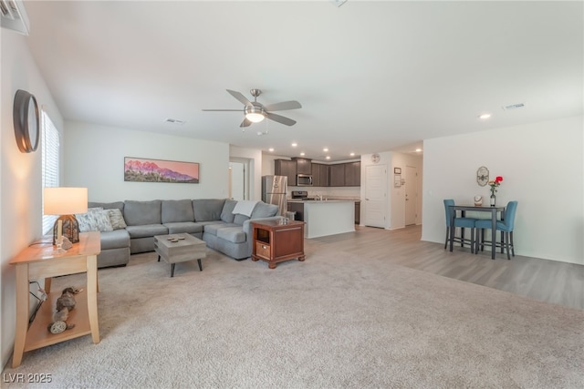 518 Descubir Ave, North Las Vegas, NV 89081 - living area featuring light colored carpet, ceiling fan, recessed lighting, and light wood-style flooring