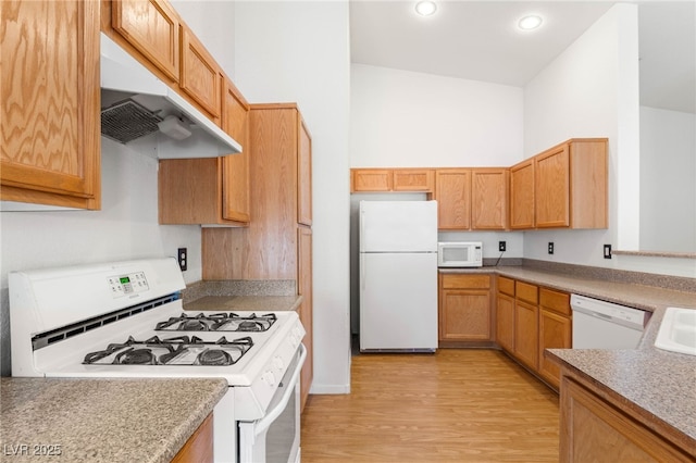 89 Day Trade St Unit 1, Henderson, NV 89074 - kitchen with white appliances, under cabinet range hood, light wood-style flooring, and recessed lighting