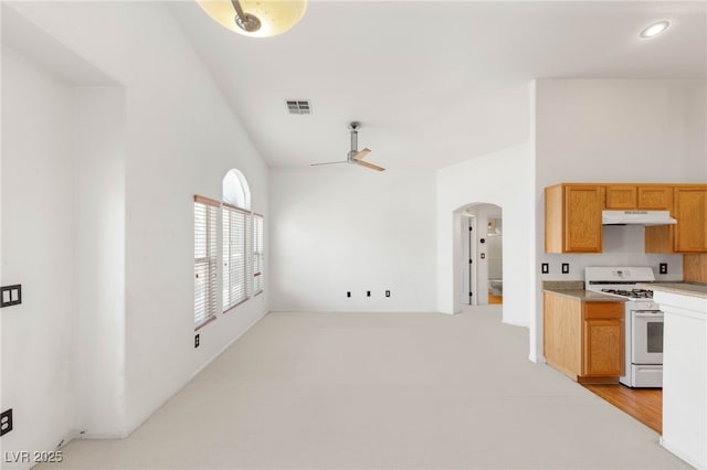 89 Day Trade St Unit 1, Henderson, NV 89074 - kitchen featuring white gas range, under cabinet range hood, a ceiling fan, light countertops, and arched walkways
