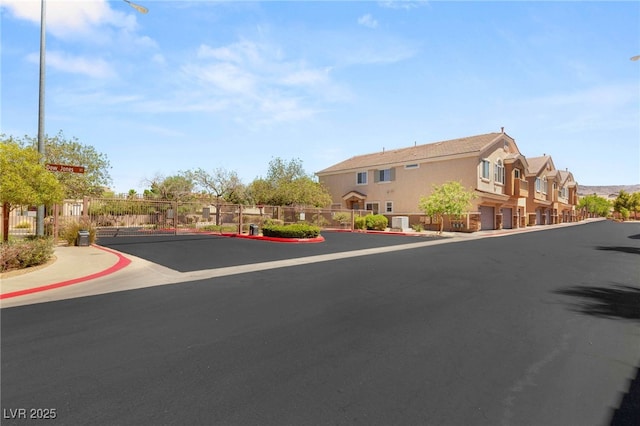 89 Day Trade St Unit 1, Henderson, NV 89074 - view of asphalt road with sidewalks, a residential view, curbs, and street lighting