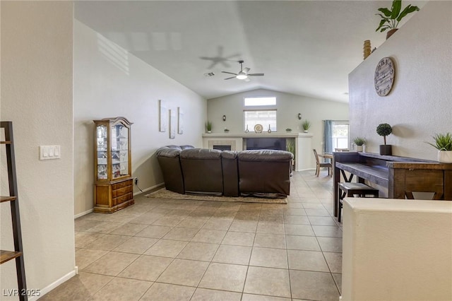 1208 Neva Ranch Ave, North Las Vegas, NV 89081 - living area featuring vaulted ceiling, a ceiling fan, light tile patterned floors, and a tile fireplace