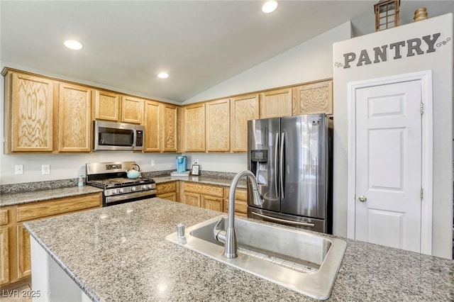 1208 Neva Ranch Ave, North Las Vegas, NV 89081 - kitchen featuring stainless steel appliances, lofted ceiling, light brown cabinetry, recessed lighting, and light stone countertops