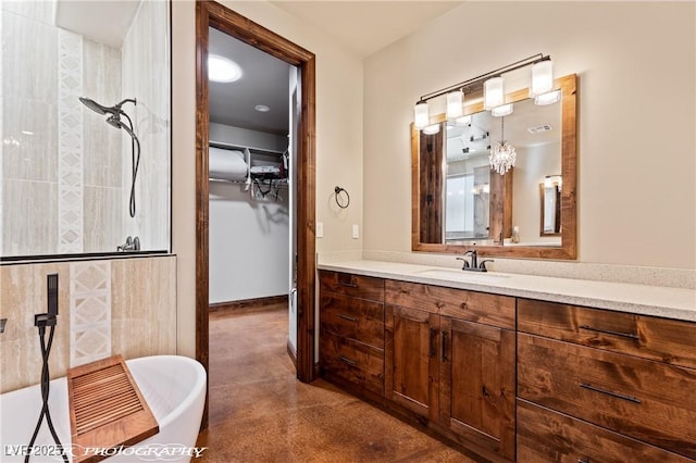479 Apogee Crst, Mesquite, NV 89027 - bathroom featuring a soaking tub, vanity, finished concrete floors, a walk in closet, and tiled shower