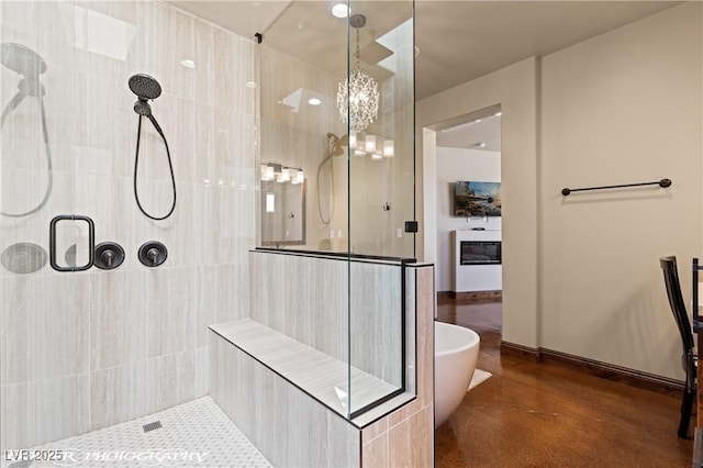 479 Apogee Crst, Mesquite, NV 89027 - bathroom with a stall shower, a freestanding tub, and a chandelier