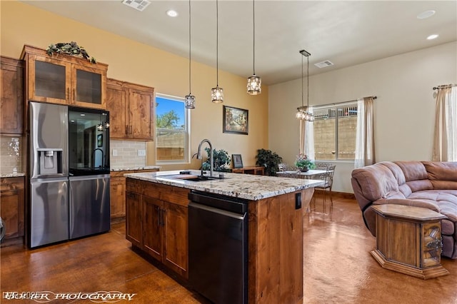 479 Apogee Crst, Mesquite, NV 89027 - kitchen featuring stainless steel fridge, black dishwasher, open floor plan, tasteful backsplash, and brown cabinetry
