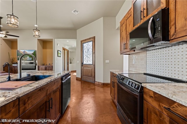 479 Apogee Crst, Mesquite, NV 89027 - kitchen with black appliances, concrete flooring, pendant lighting, light stone counters, and tasteful backsplash