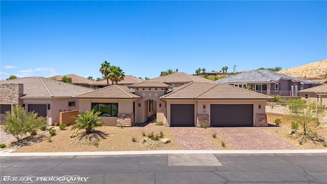479 Apogee Crst, Mesquite, NV 89027 - view of front of house with an attached garage, stucco siding, driveway, and a tiled roof