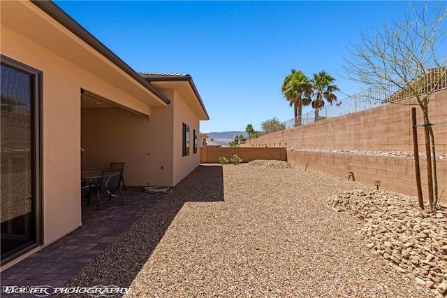 479 Apogee Crst, Mesquite, NV 89027 - fenced backyard with a patio and a mountain view