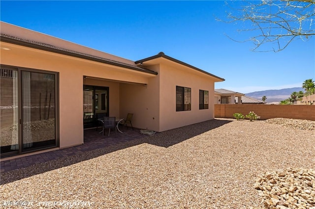 479 Apogee Crst, Mesquite, NV 89027 - rear view of house featuring stucco siding, a patio area, and a mountain view