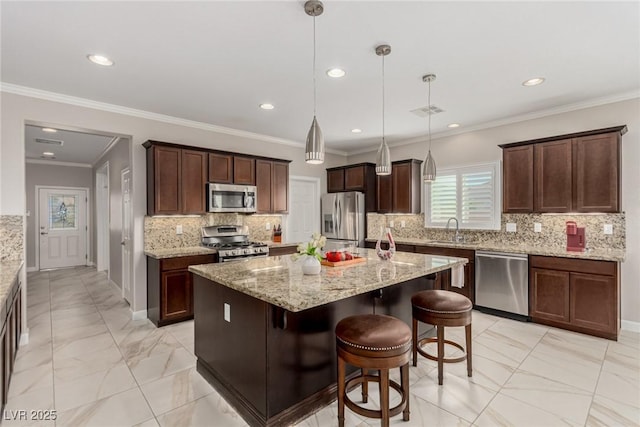 1304 Fantastic Ct, North Las Vegas, NV 89081 - kitchen featuring stainless steel appliances, recessed lighting, light marble finish floors, a center island with sink, and decorative backsplash